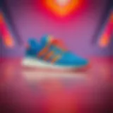 Stylish Adidas blue and orange sneakers on a vibrant background
