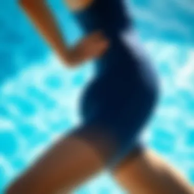 A swimmer showcasing sleek swim tights against a clear blue pool background.